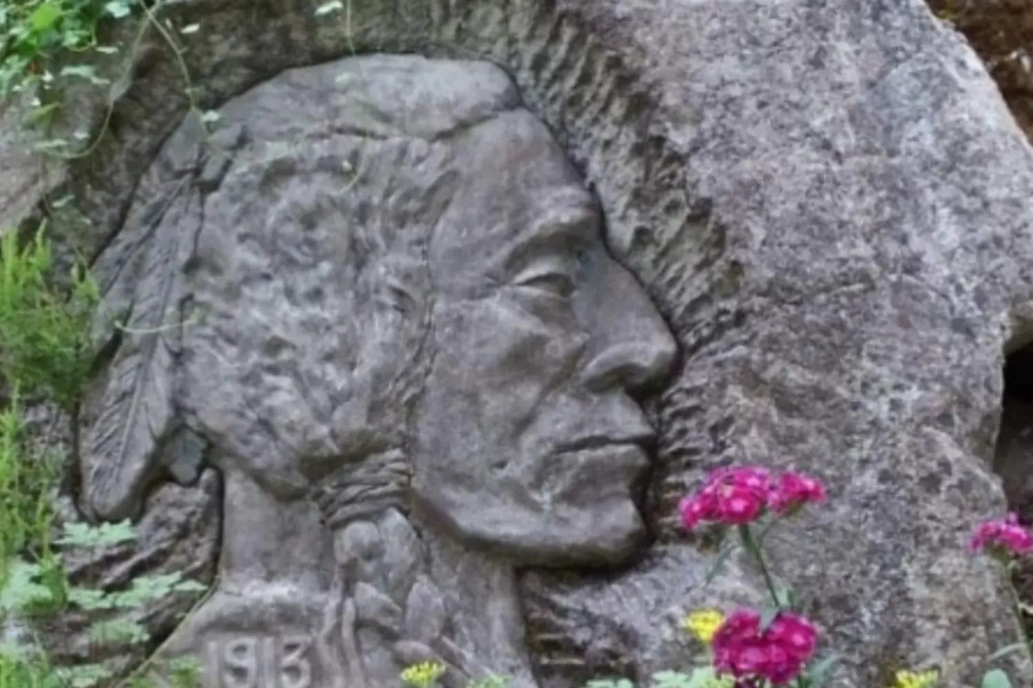 Stone carving of a Native American profile.
