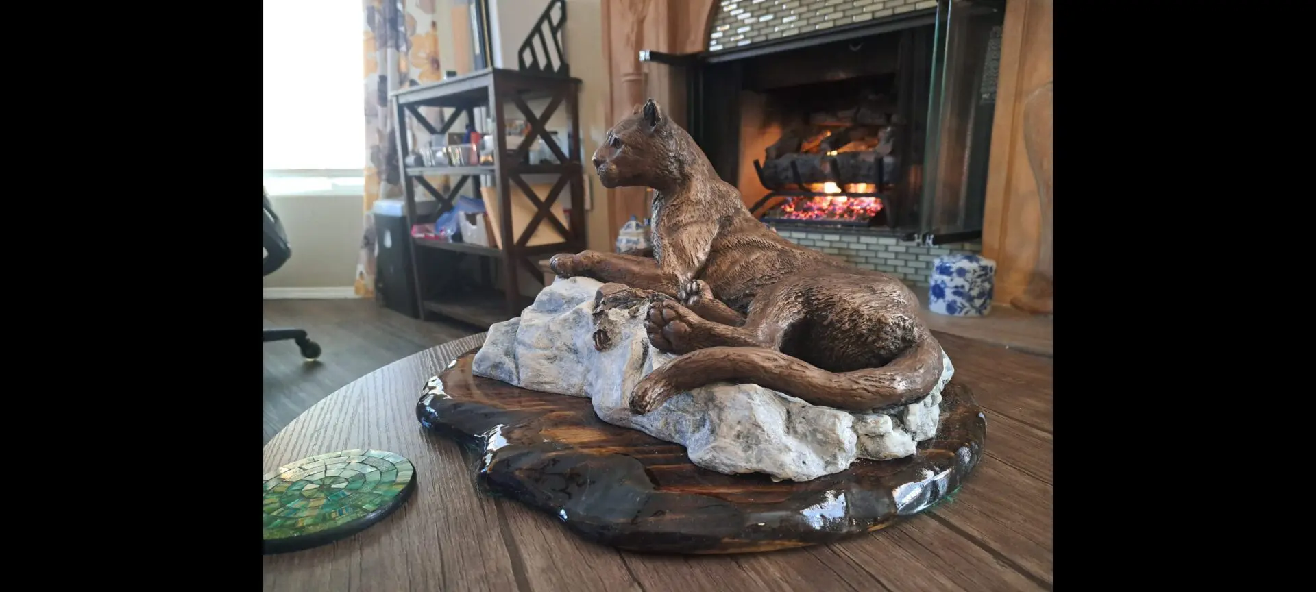 Mountain lion sculpture on a wooden table.