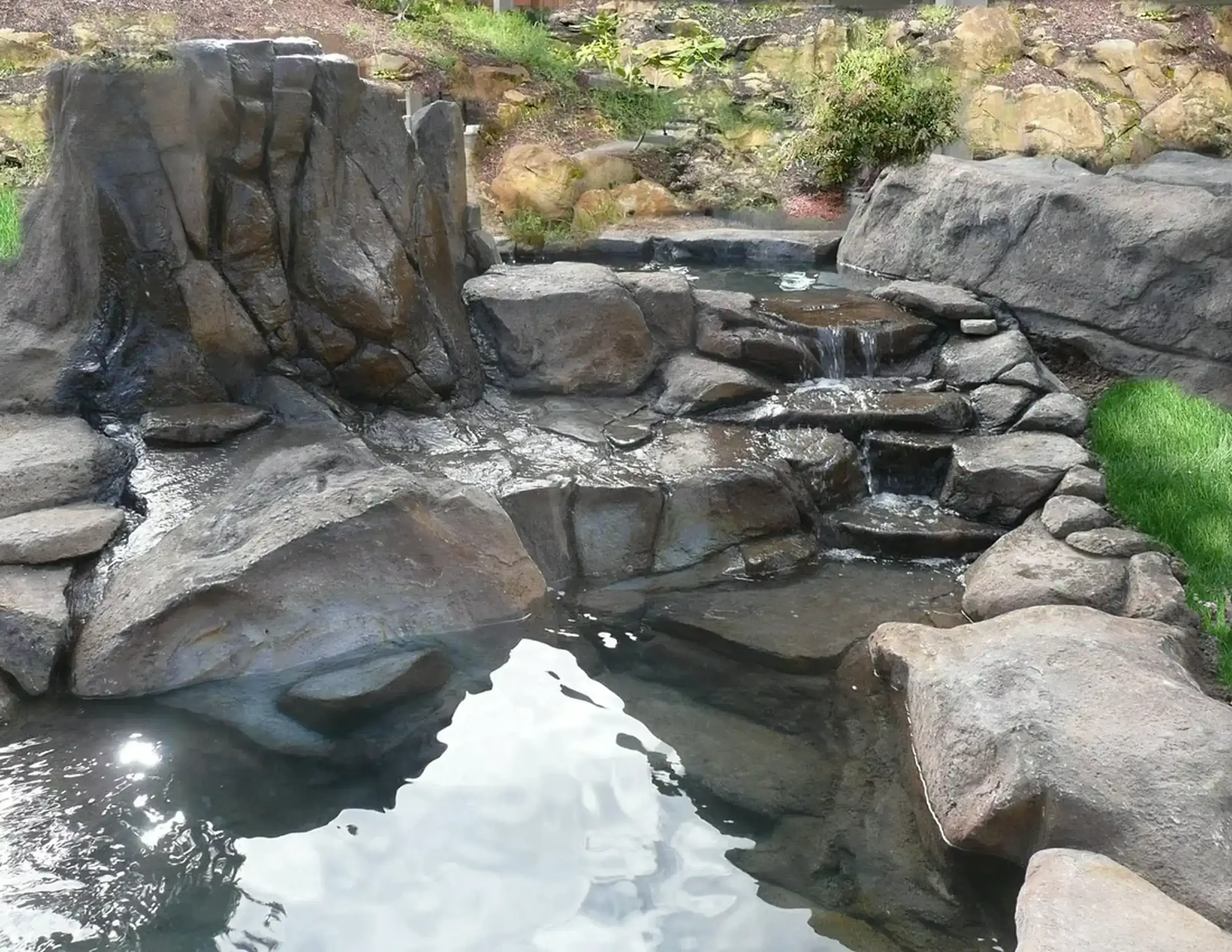 Rocky waterfall with small cascading pools.