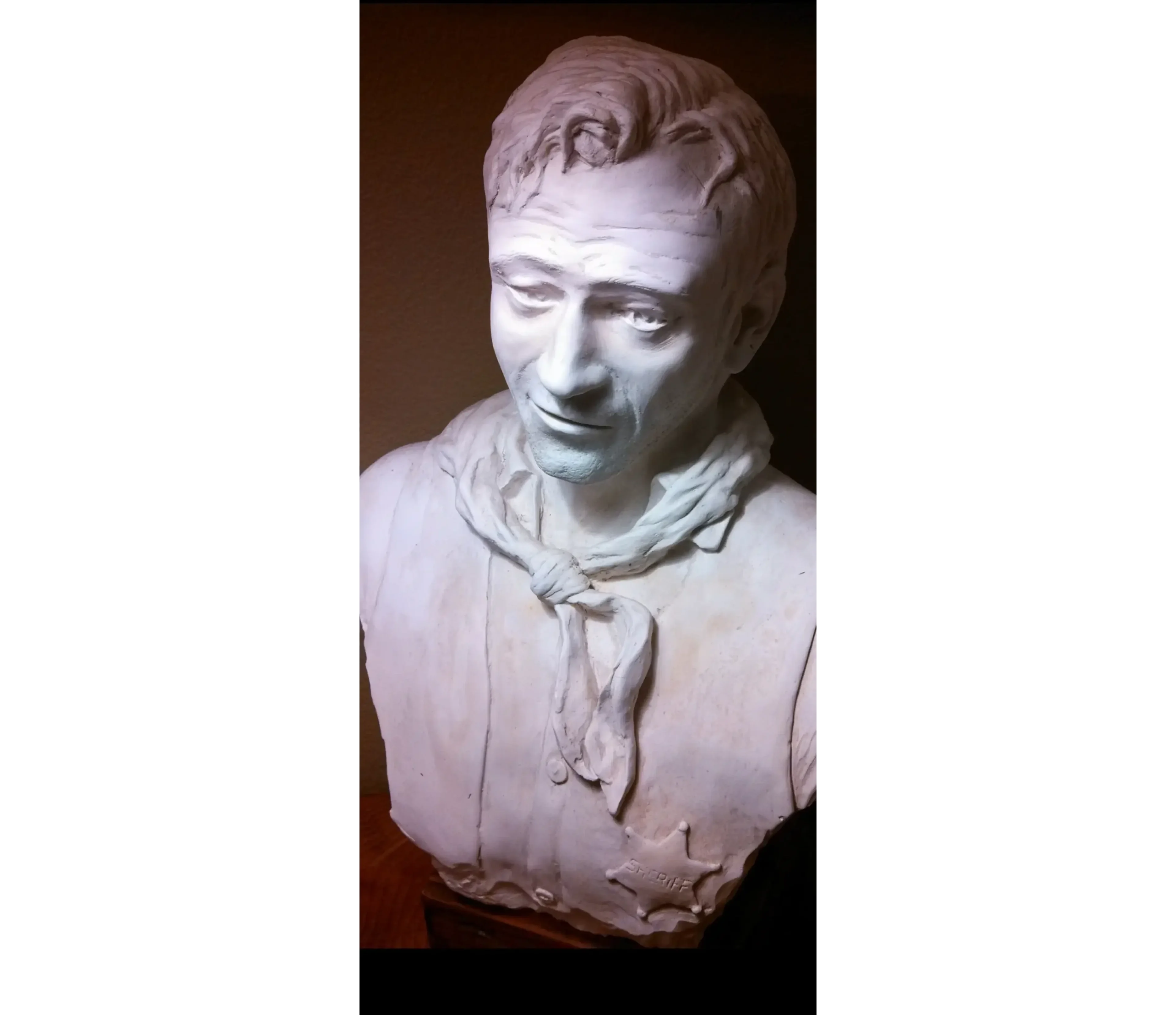 Bust sculpture of a man with scarf.